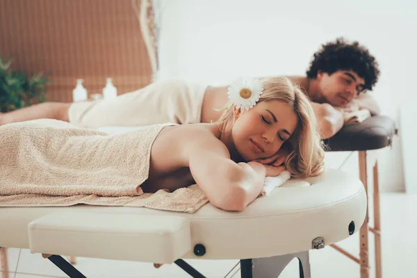 A couple relaxing together on massage tables during a couples massage