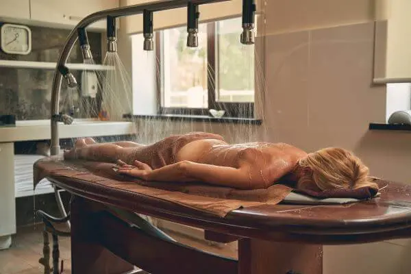 Guest receiving a Vichy shower hydrotherapy treatment