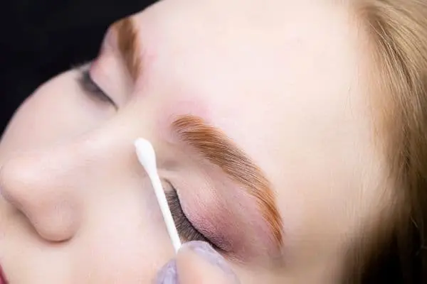 Close-up of expertly tinted lashes and defined brows after a professional tinting service