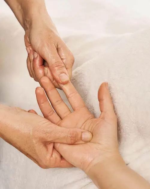 Therapist performing a careful hand massage