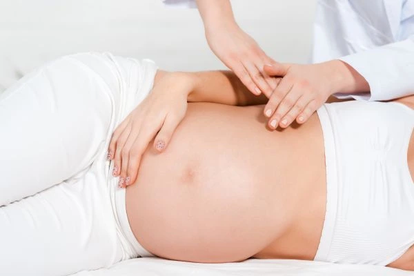 Expectant mother receiving a gentle prenatal massage