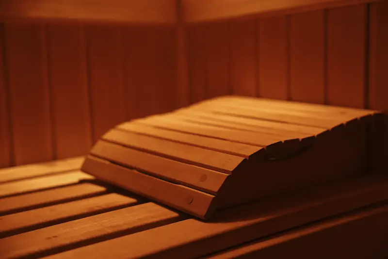Warm wooden sauna interior with bench seating and soft ambient lighting